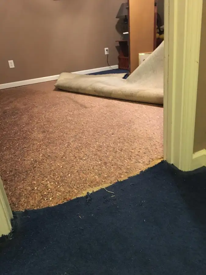 Carpet pad removal revealing water damage during Water Mitigation Services in Fresno